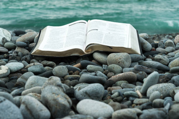 istock Bible, stones and sea. 972349890