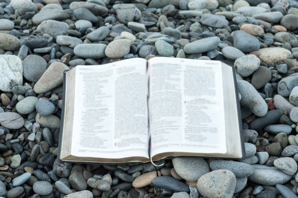 istock Bible and stones. Close-up. 972349902