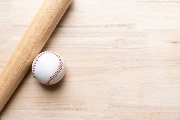 baseball and baseball bat on wooden table background, close up - baseball bat fotos imagens e fotografias de stock