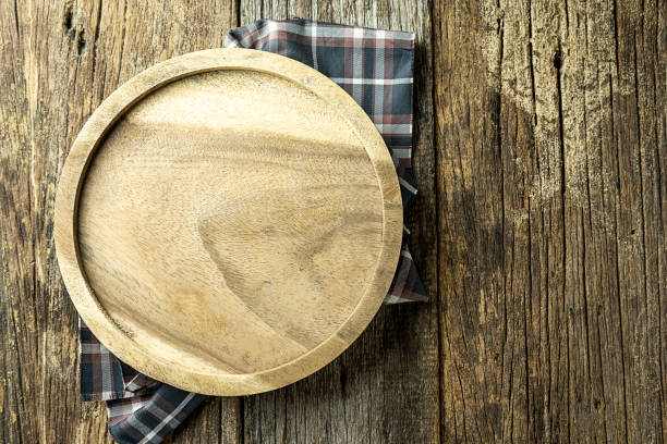istock Round cutting board on old wooden,Top view. Copy space. 972360998