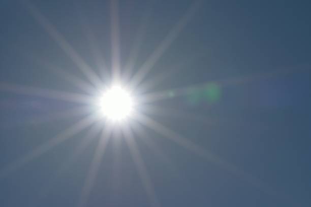 istock Nature background shining sun with solar flares 972361560