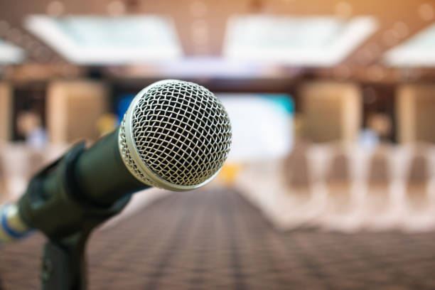 istock Seminar Conference Concept : Microphones for speech or speaking  in seminar room, talking for lecture to audience university, Event light convention hall Background. 972364260