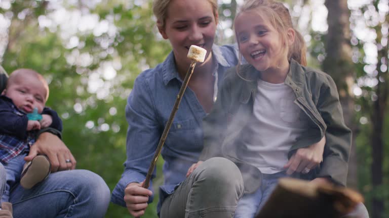 Mother and daughter roasting a marshmallow