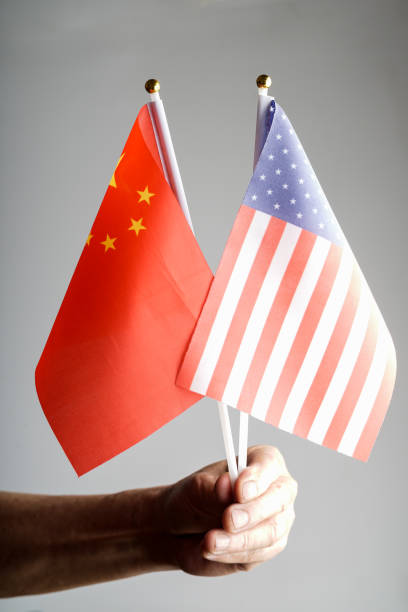 istock China amd USA flag with grey background studio shot 972372276