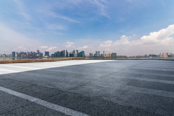 istock Panoramic skyline and modern business office buildings with empty road,empty concrete square floor 972374492