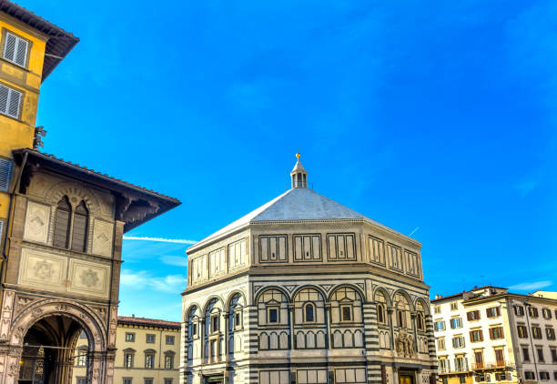 Piazza del Duomo in the early morning. The Baptistery of St. John, standing in front of Giotto's Bell tower and Duomo of Florence, Italy