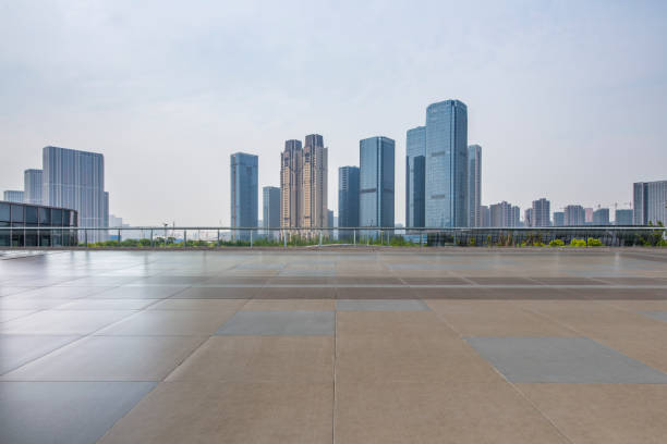 istock Panoramic skyline and modern business office buildings with empty road,empty concrete square floor 972384218