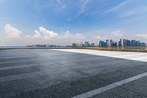 istock Panoramic skyline and modern business office buildings with empty road,empty concrete square floor 972389054