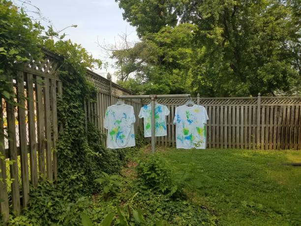 istock white shirts with paint hanging to dry 972391114
