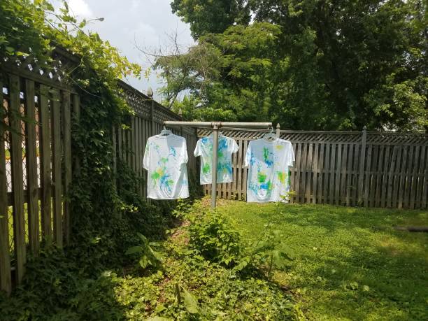istock white shirts with paint hanging to dry 972391218