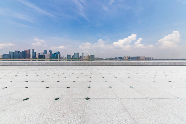 istock Panoramic skyline and modern business office buildings with empty road,empty concrete square floor 972391242