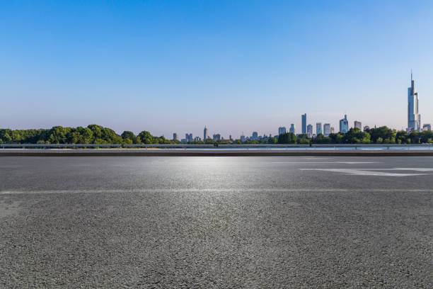 istock Panoramic skyline and modern business office buildings with empty road,empty concrete square floor 972391432