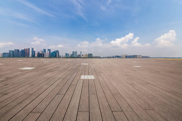 istock Panoramic skyline and modern business office buildings with empty road,empty concrete square floor 972393584
