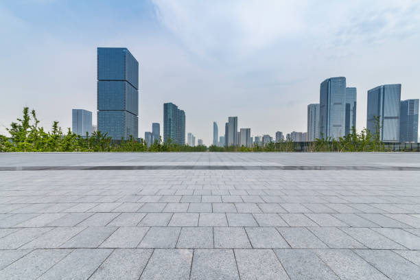 istock Panoramic skyline and modern business office buildings with empty road,empty concrete square floor 972393644