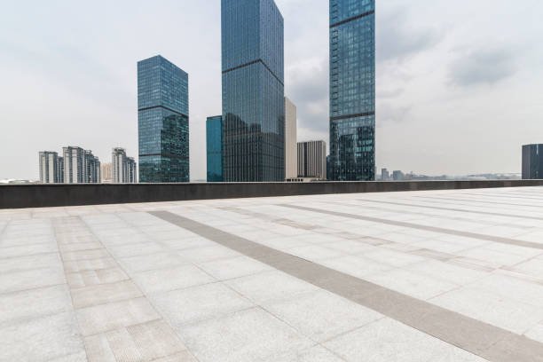 istock Panoramic skyline and modern business office buildings with empty road,empty concrete square floor 972398240