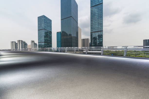 istock Panoramic skyline and modern business office buildings with empty road,empty concrete square floor 972398260