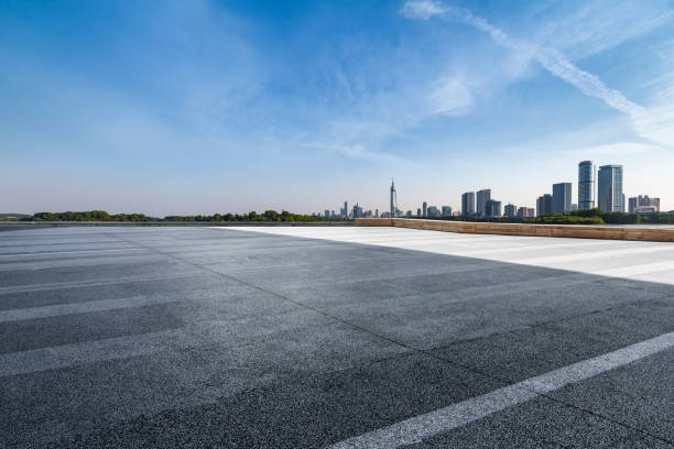 istock Panoramic skyline and modern business office buildings with empty road,empty concrete square floor 972405300