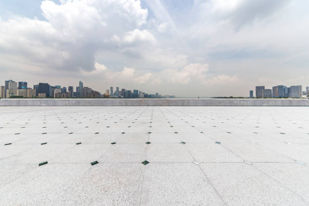 istock Panoramic skyline and modern business office buildings with empty road,empty concrete square floor 972414728
