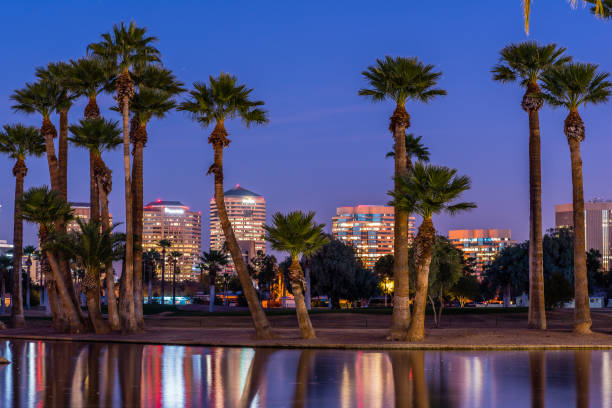 Phoenix Office Buildings at Night The lights of downtown Phoenix office buildings are reflected in the waters of the Encanto Park lagoon. phoenix arizona stock pictures, royalty-free photos & images