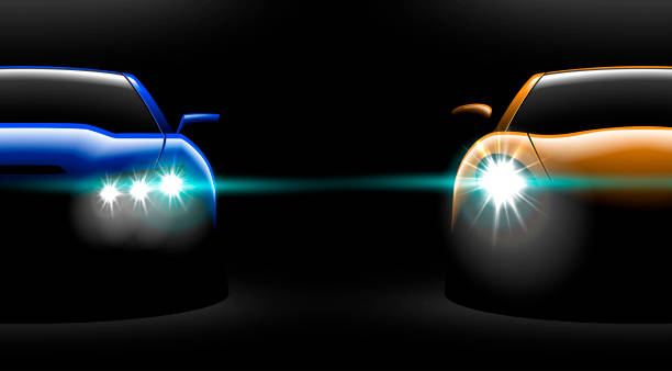 istock realistic yellow blue two sport car view with unlocked headlights in the dark 972420170
