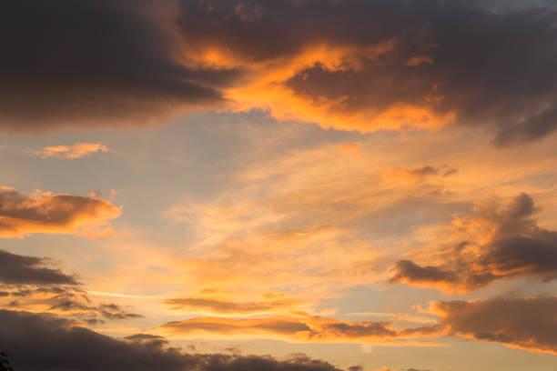 istock clouds heavy sunrise colors , spring morning background 972420196