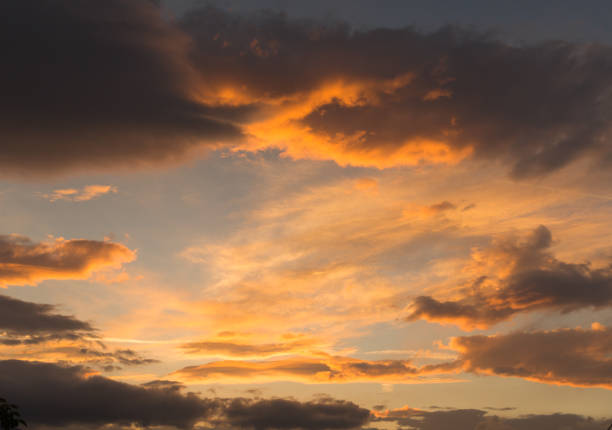 istock clouds heavy sunrise colors , spring morning background 972420198