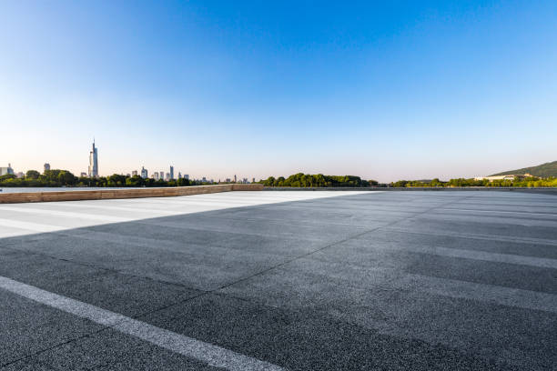 istock Panoramic skyline and modern business office buildings with empty road,empty concrete square floor 972420462