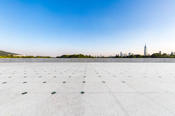 istock Panoramic skyline and modern business office buildings with empty road,empty concrete square floor 972420502