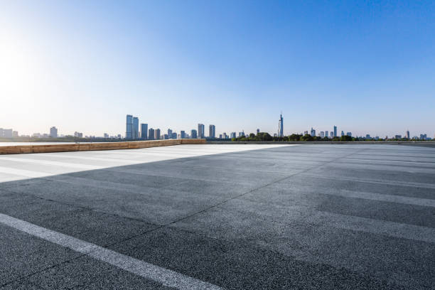 istock Panoramic skyline and modern business office buildings with empty road,empty concrete square floor 972420600