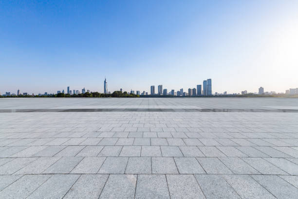 istock Panoramic skyline and modern business office buildings with empty road,empty concrete square floor 972420622
