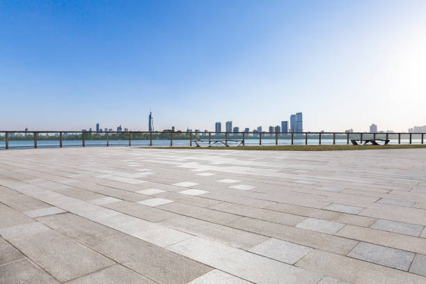 istock Panoramic skyline and modern business office buildings with empty road,empty concrete square floor 972420670
