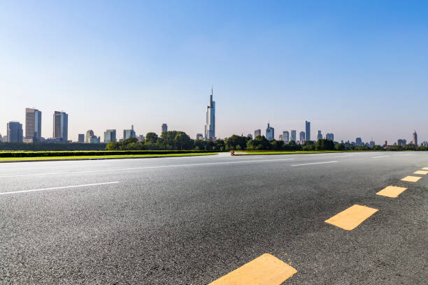 istock Panoramic skyline and modern business office buildings with empty road,empty concrete square floor 972423080
