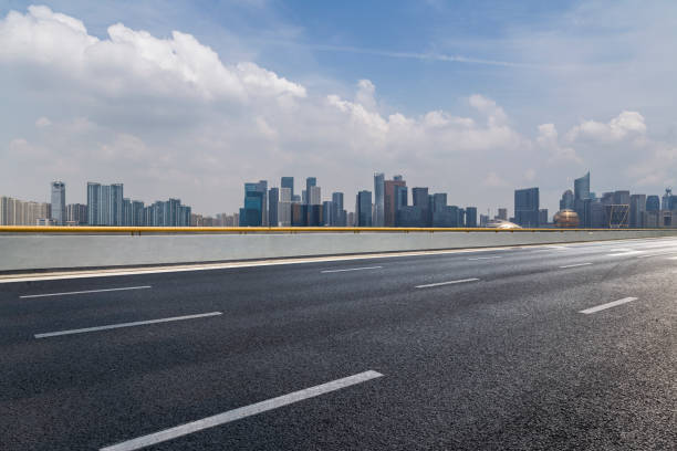 istock Panoramic skyline and modern business office buildings with empty road,empty concrete square floor 972425560