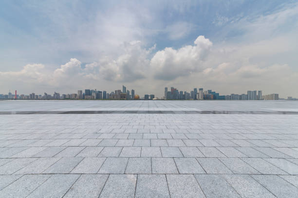 istock Panoramic skyline and modern business office buildings with empty road,empty concrete square floor 972425884