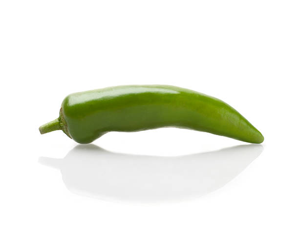 Green Chilli Pepper on reflective white background stock photo