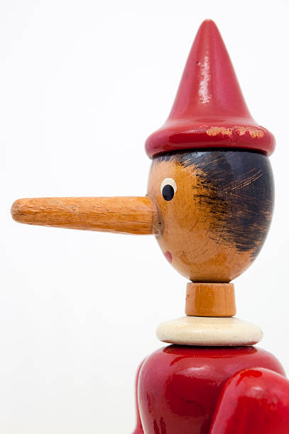 istock Old wooden toy puppet with long nose 97245445