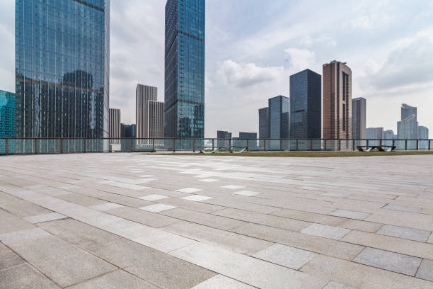 istock Panoramic skyline and modern business office buildings with empty road,empty concrete square floor 972458920