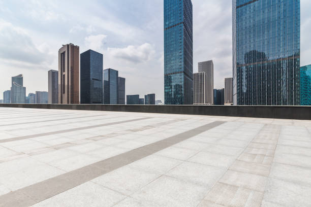 istock Panoramic skyline and modern business office buildings with empty road,empty concrete square floor 972459100