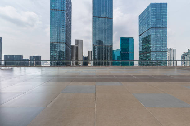 istock Panoramic skyline and modern business office buildings with empty road,empty concrete square floor 972460972