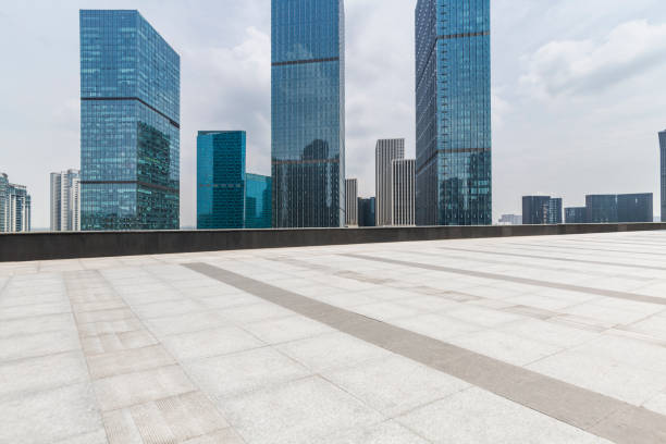istock Panoramic skyline and modern business office buildings with empty road,empty concrete square floor 972465530