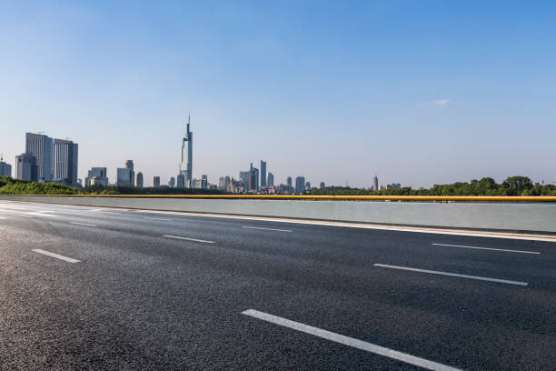 istock Panoramic skyline and modern business office buildings with empty road,empty concrete square floor 972465648