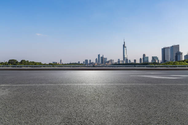 istock Panoramic skyline and modern business office buildings with empty road,empty concrete square floor 972465670