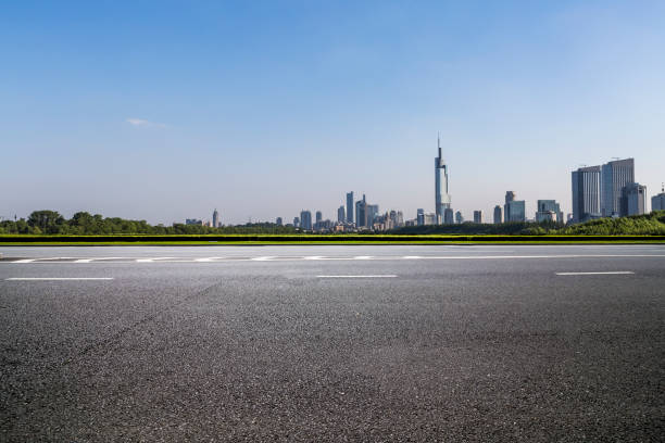 istock Panoramic skyline and modern business office buildings with empty road,empty concrete square floor 972465704