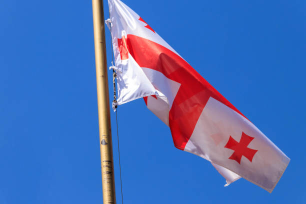 istock Georgian flag against blue sky 972468268