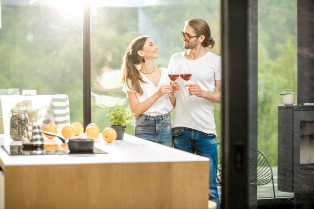 istock Young couple with wine at home 972476066