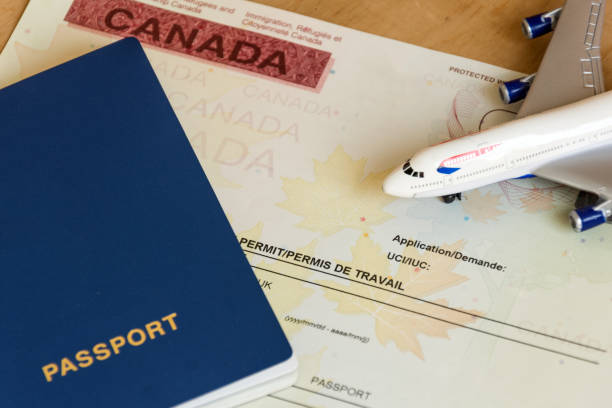 canadian work permit paper document and passport top view. - emigration and immigration passport passport stamp usa imagens e fotografias de stock