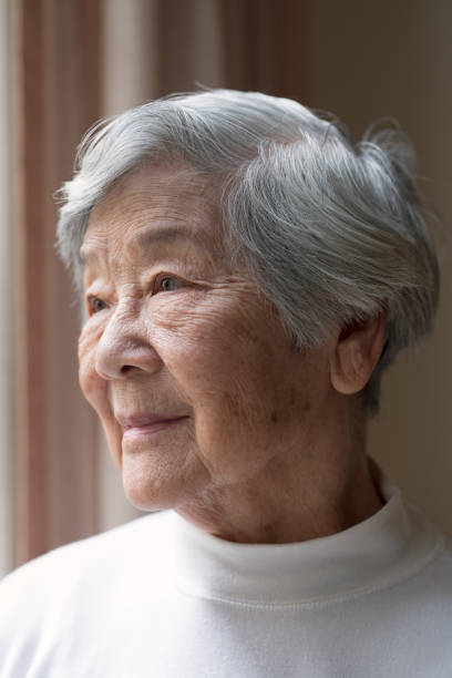 istock Senior Asian Woman Looking out Window 972500892