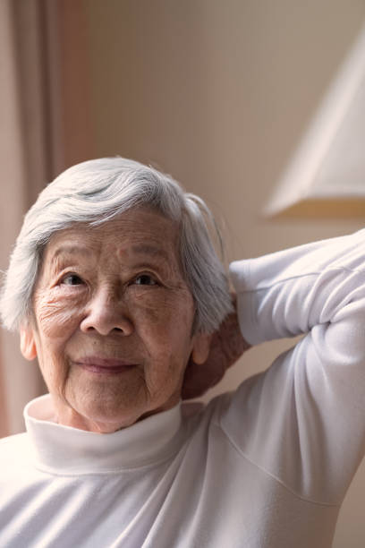 istock Senior Asian Woman Performing Stretching and Flexibility Exercise 972500996