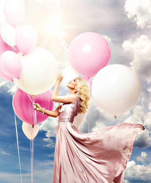istock beautiful girl with balloons 972506542