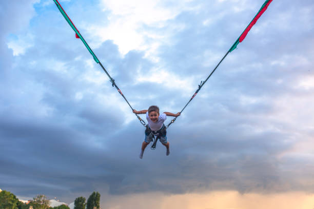 istock Boy bungee jumping before the storm 972514814